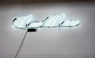 White neon sign- 'Mona More'