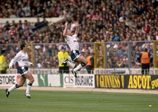 Paul Gascoigne of Tottenham Hotspur leaps in the air in celebration after scoring the opening goal, with a free-kick, of the 1991 FA Cup semi-final against Arsenal at Wembley