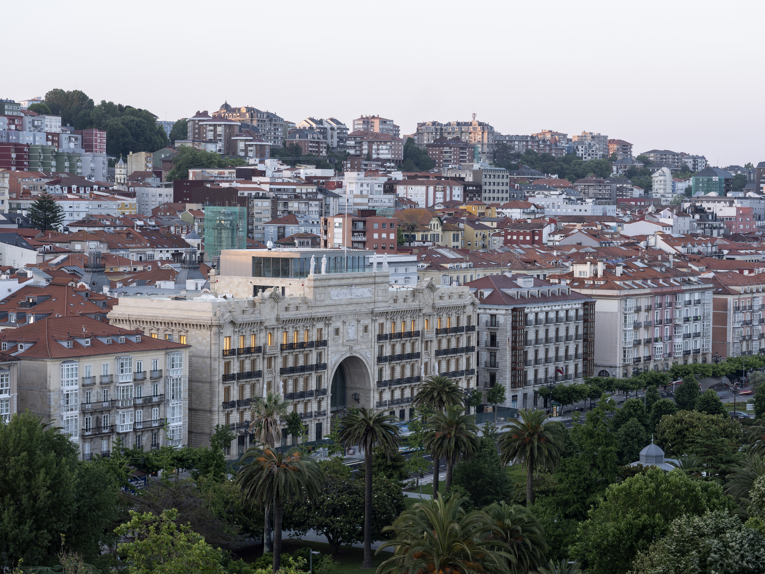 exterior of Faro Santander seen from the air, across trees