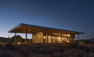 Jeremy Levine's sustainable house in a nighttime setting among nature