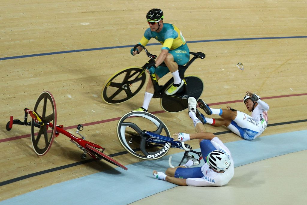 South Korea's Park Sanghoon and Elia Viviani (Italy) hit the deck as Glenn O'Shea (Australia) tries to stay upright