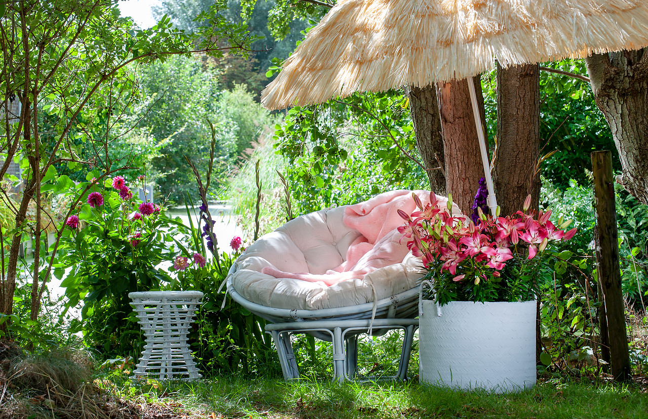 Anne Verdoes shoots small beachy looking corner of a garden complete with a straw parasol