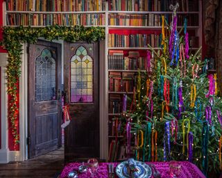 library with stained glass doors in victorian house turned into a dining room and decorated for christmas with jewel colors