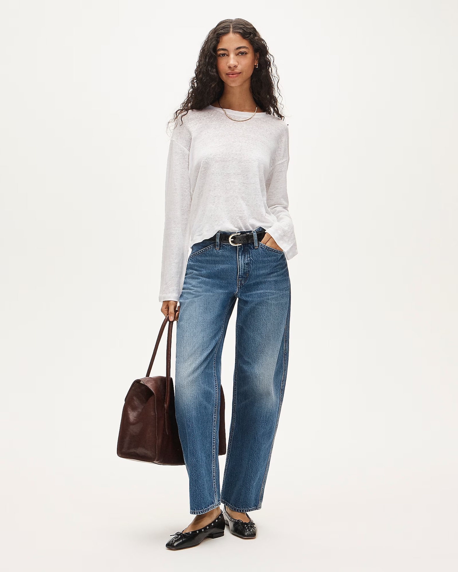 J.Crew outfit with a white linen T-shirt, black belt, barrel jeans, a burgundy bag, and black ballet flats