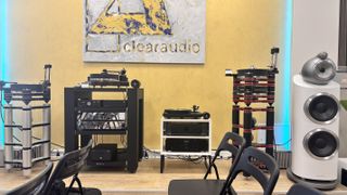 Clearaudio turntables on racks with logo in the background