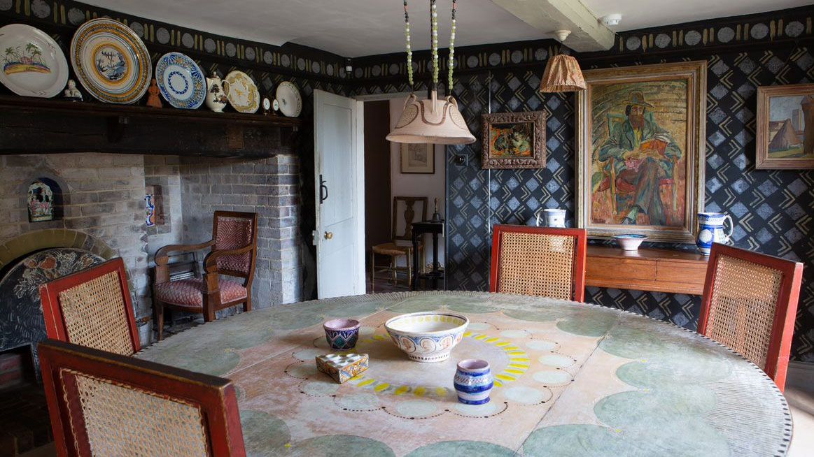 Charleston House dining room with hand stencilled walls and decorated table