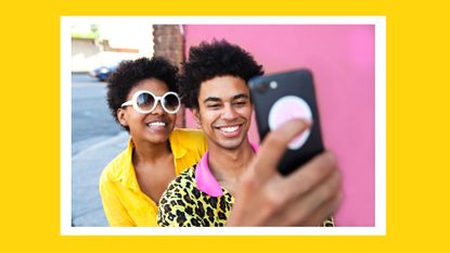 A young couple wearing yellow clothes taking a selfie in front of a pink wall, relationship timeline