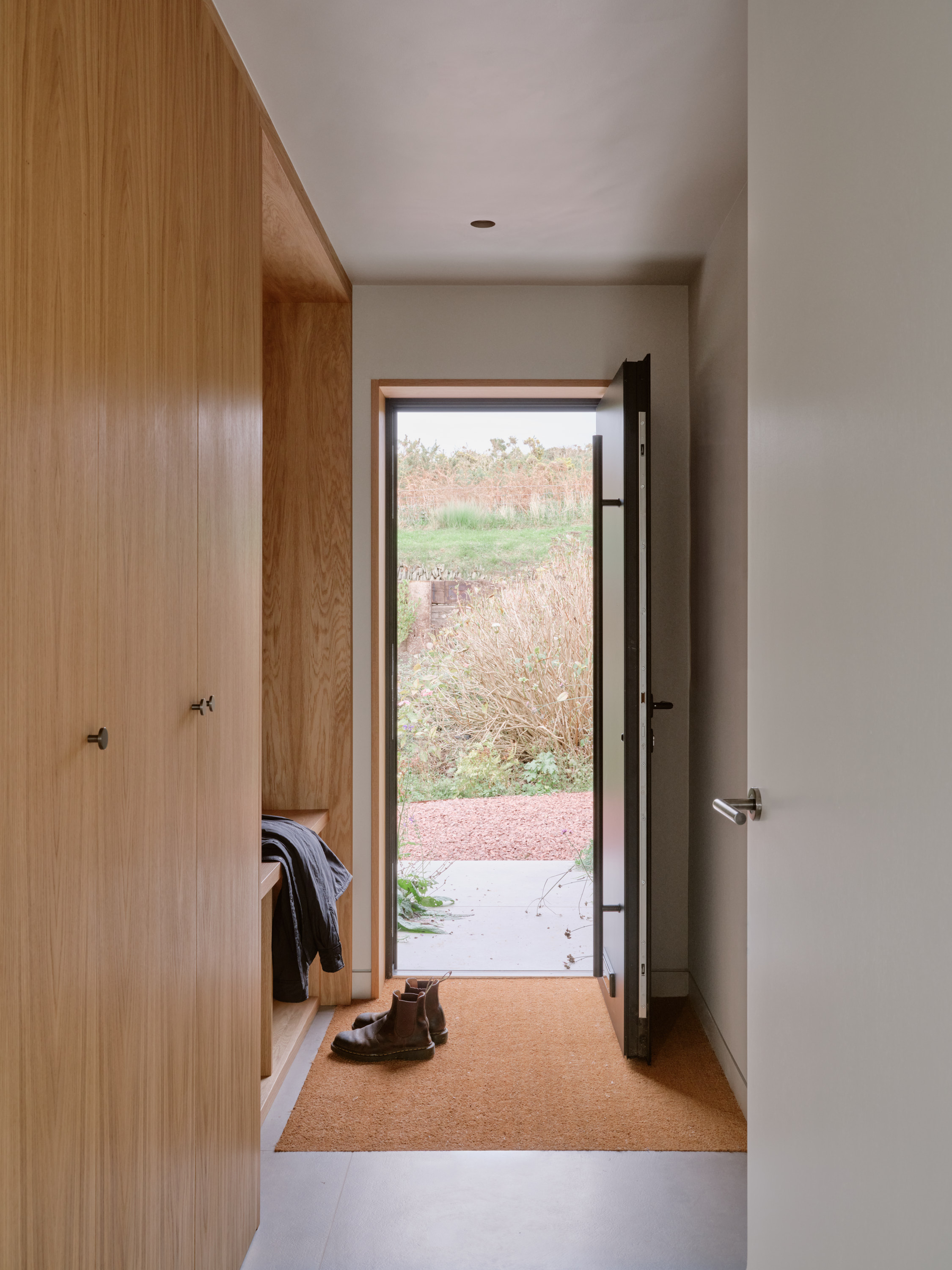 view of a welsh cottage or bungalow type building facing the sea and redesigned in a fairly minimalist, contemporary way