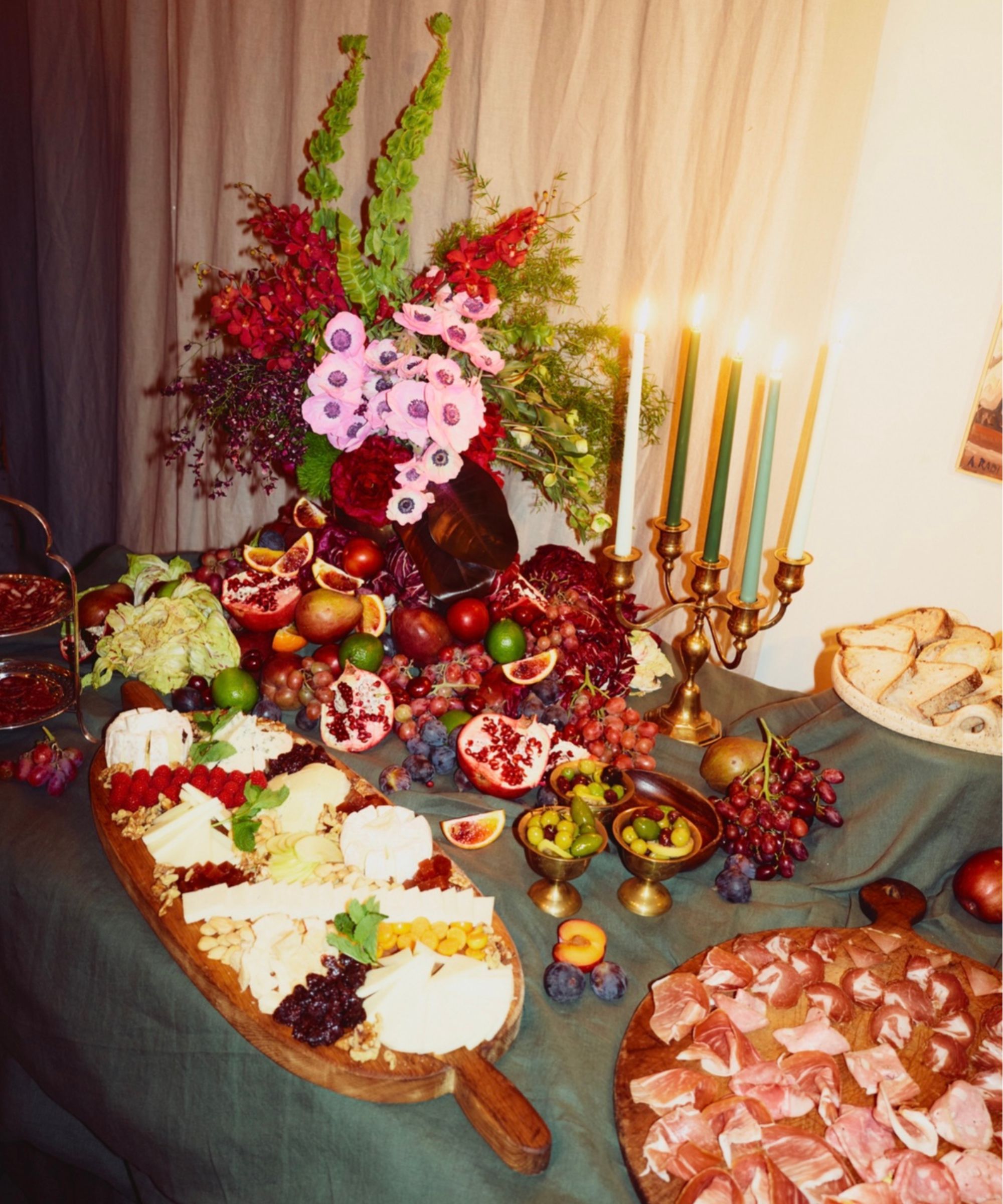 Grazing table with meat, cheese, flowers and candles