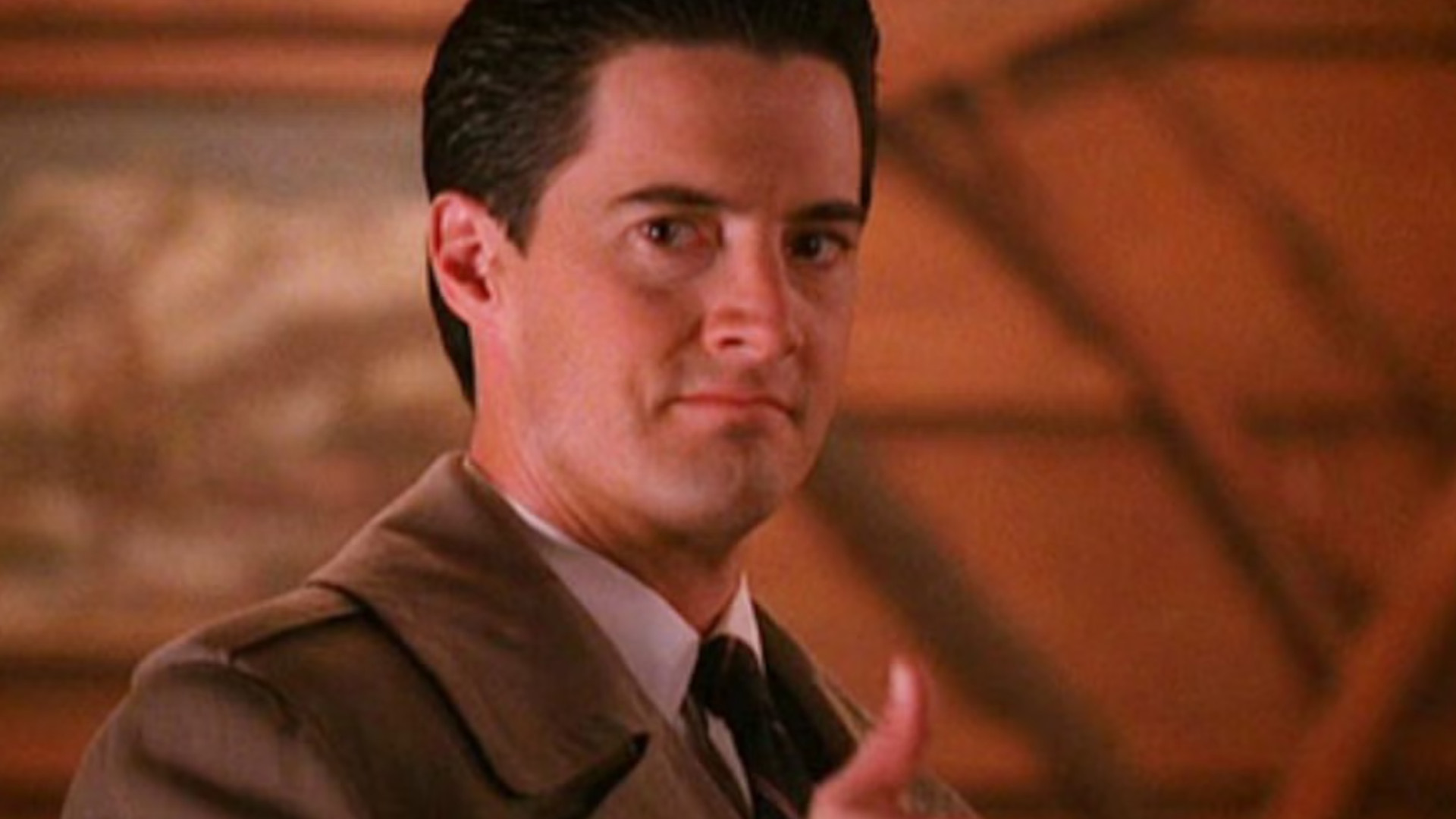 Kyle MacLachlan as Special Agent Dale Cooper giving a thumbs up during one of the best David Lynch shows, Twin Peaks.