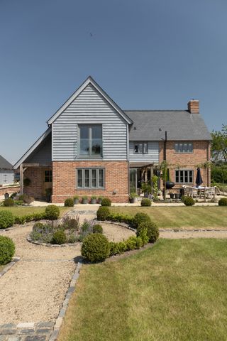 A Handmade Brick House with a Modern Timber Rear