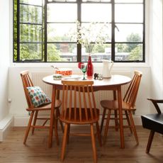 A dining room with a vintage table and chairs