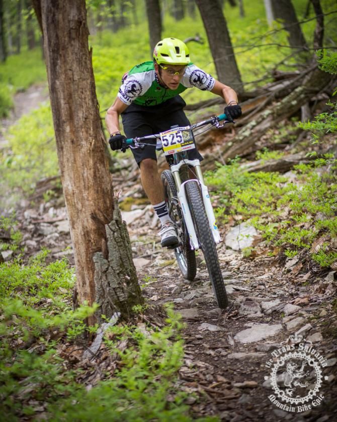 Cody Philips dodges a trailside tree during a downhill enduro section