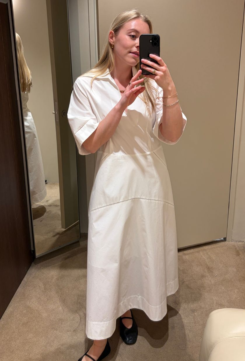 Woman wears white shirt dress, black ballet flats