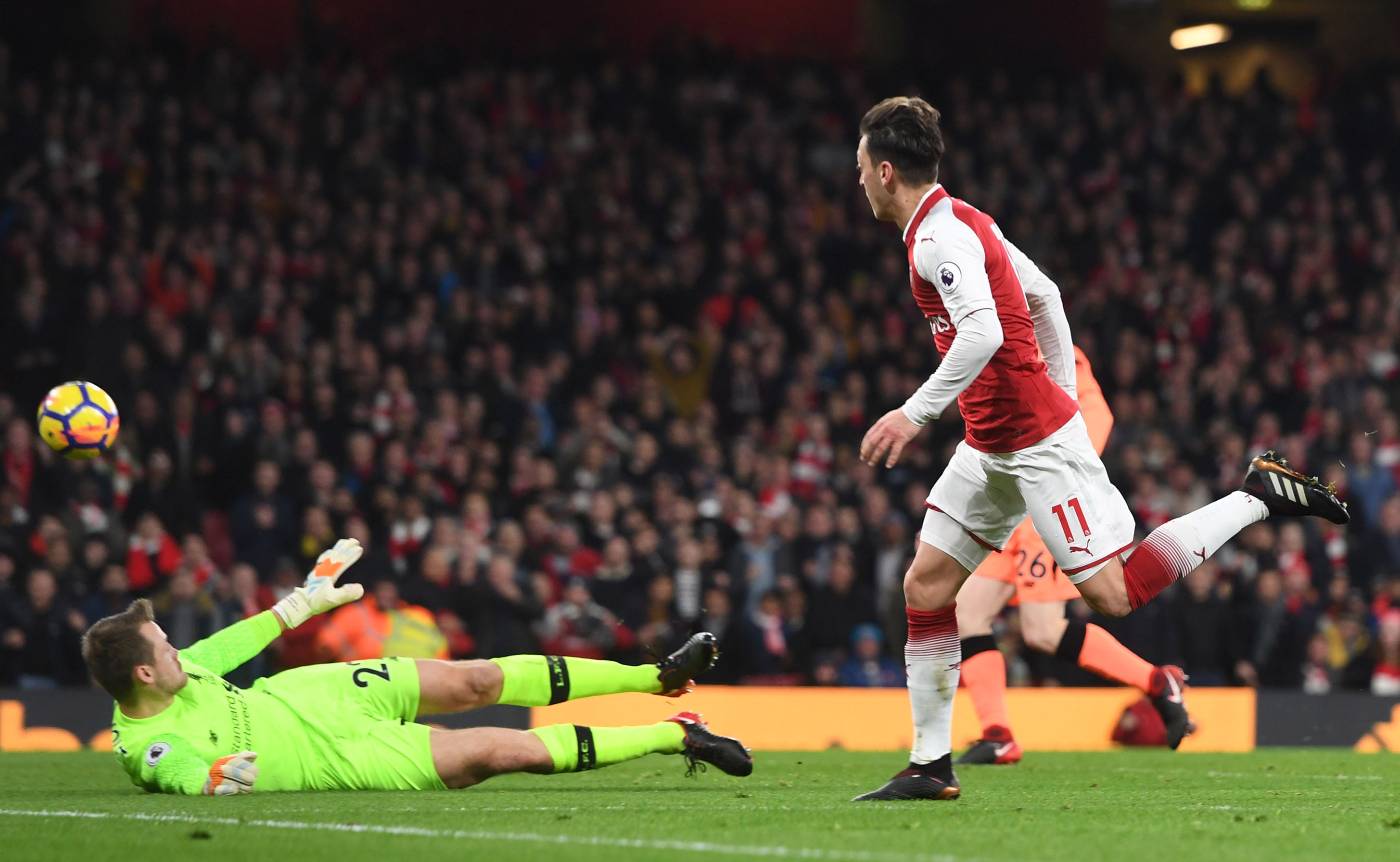 Mesut Ozil scores for Arsenal against Liverpool in December 2017.