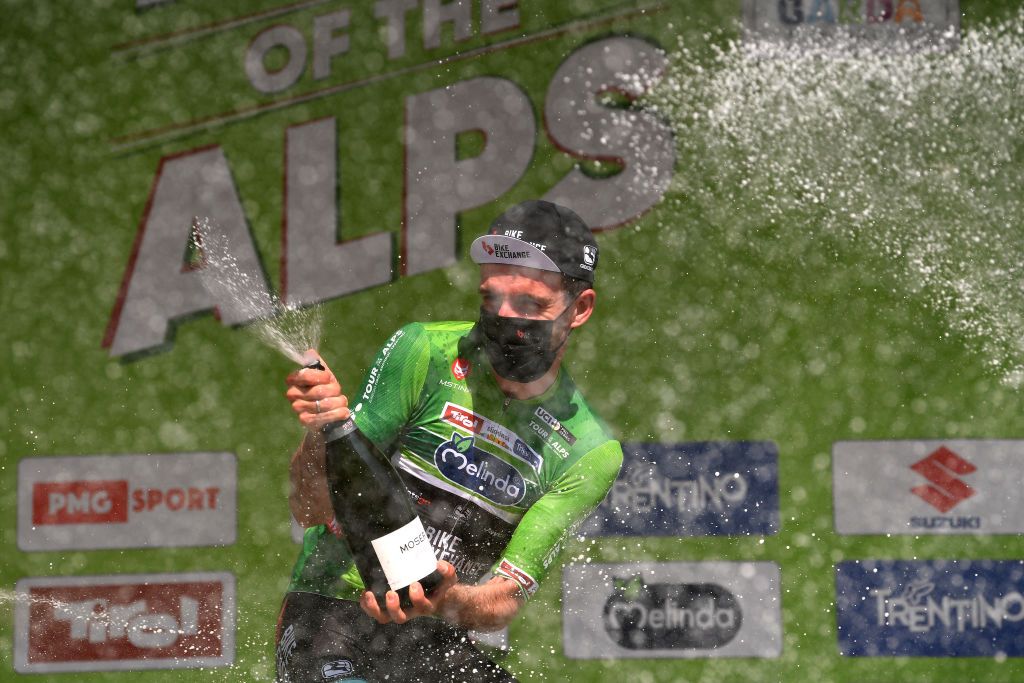 RIVA DEL GARDA ITALY APRIL 23 Simon Yates of United Kingdom and Team BikeExchange Green Leader Jersey celebrates at final podium during the 44th Tour of the Alps 2021 Stage 5 a 1209km stage from Valle del Chiese Idroland to Riva del Garda Champagne Mask Covid Safety Measures TourofTheAlps TouroftheAlps on April 23 2021 in Riva del Garda Italy Photo by Tim de WaeleGetty Images