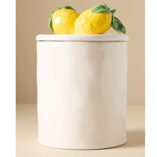 White ceramic storage jar with lemons on top