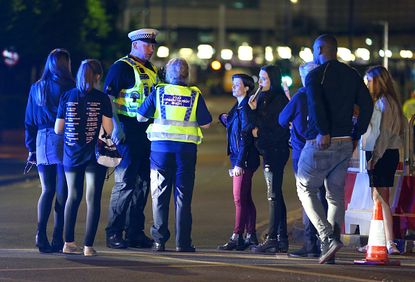 Police talk with people who escaped from the Manchester Arena.