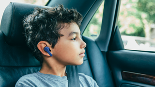 Young boy wearing Belkin Soundform Nanon wireless earbuds
