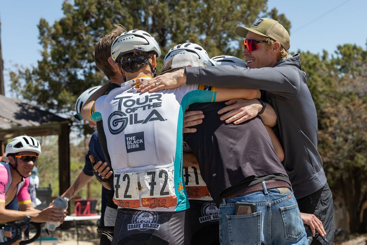 Alan Schroder, Xander White, Scott Sunderman (team mechanic), and Tanner Ward envelope Sean Gardner in a hug when the announcement was made that Sean won the overall GC.