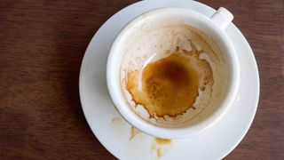 picture of a coffee cup and saucer with coffee stains inside it