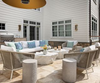 Patio with rattan furniture with blue and white cushions