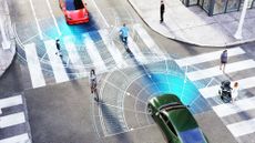 A graphic showing cars sensing the position of pedestrians at a busy urban road junction