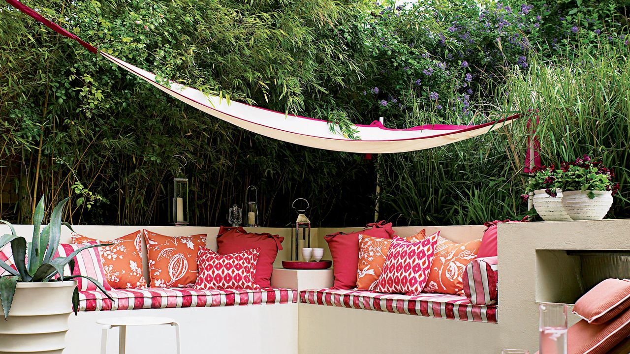 Pink outdoor seating area with a pink trim shade sail