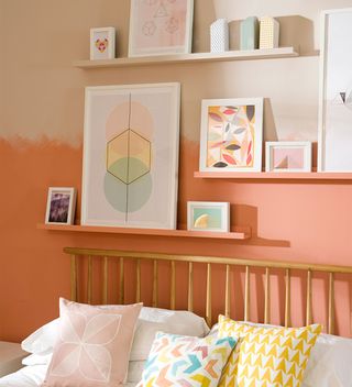 two tone orange bedroom with picture display