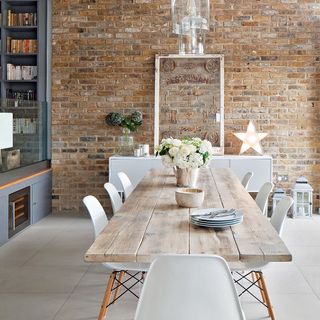 room with wooden table and brick wall