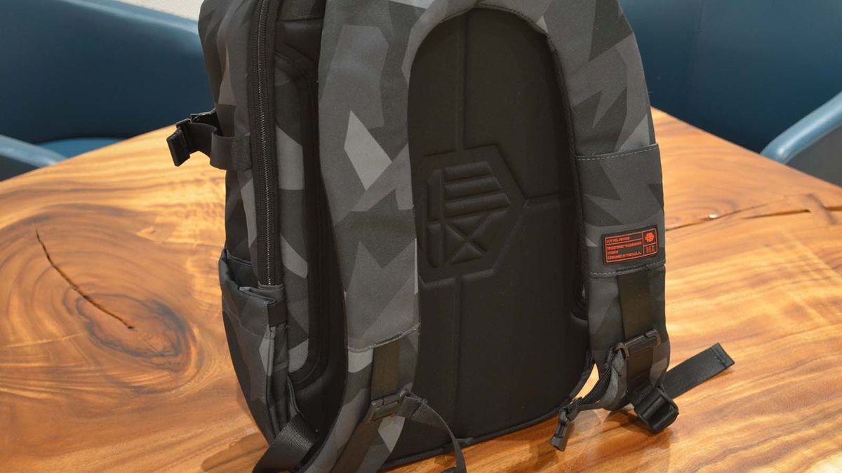 A Hex Technical Backpack on a wood grain table