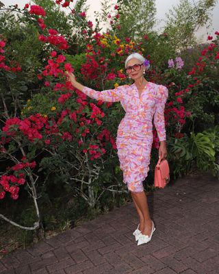 Grace Ghanem in floral dress and heels.