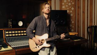 Finneas holds his signature Acoustasonic Telecaster