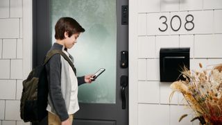 Masonite M-Pwr Smart Door being controlled by young boy with smartphone