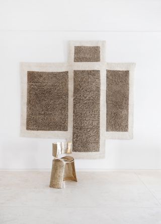 wall hangings and a chair in white space of Æquō design gallery, India