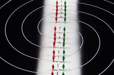 Winter Olympics Opening Ceremony: models wearing the colours of the Italian flag walk across the stadium, in suits by Giorgio Armani