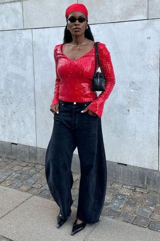 Marilyn in red top and black jeans