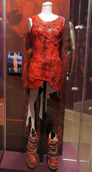 Dress, Red, One-piece garment, Mannequin, Fashion, Retail, Maroon, Display case, Cocktail dress, Day dress,