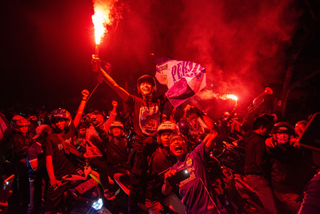 Fans celebrate a win by Persib Bandung football club by lighting flares in Bandung, West Java, Indonesia.