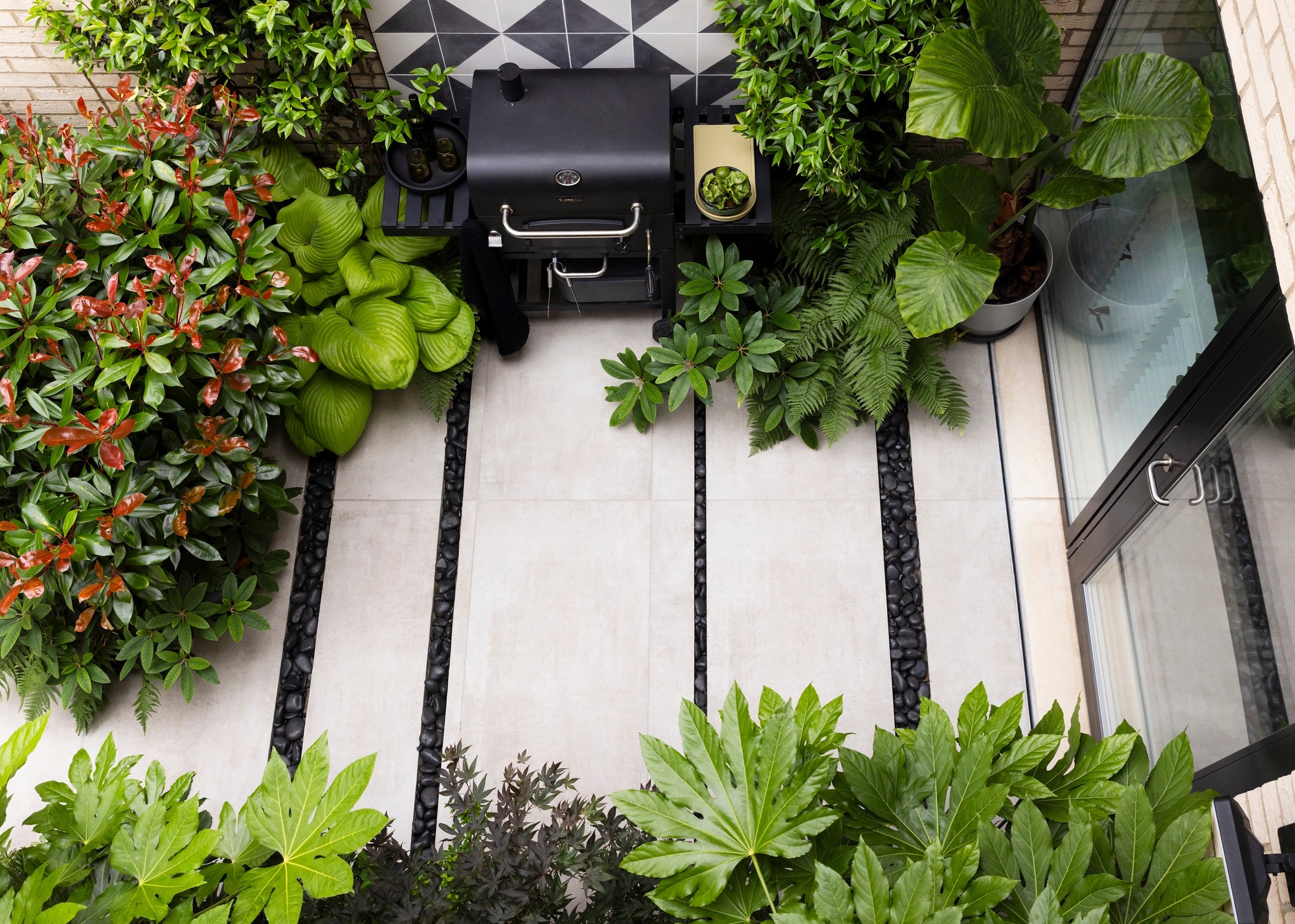overhead view of large stone slab patio with attractive drainage channels and plantings