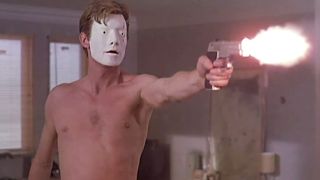 Jason Flemyng wearing the featureless mask, at the end of his rope, no shirt, and firing his gun in George A. Ramero's 2000 flick "Bruiser."