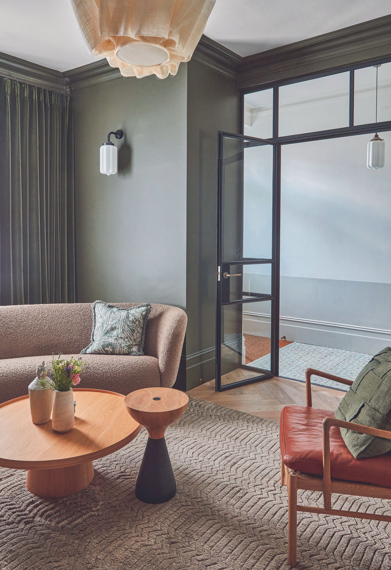 Internal glass doors leading from the entryway into the living room of this terraced London house