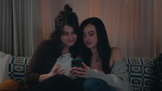 Sofia Black-D'Elia and cazzie david as mackenzie and ally looking at an iphone on the couch in i love you forever