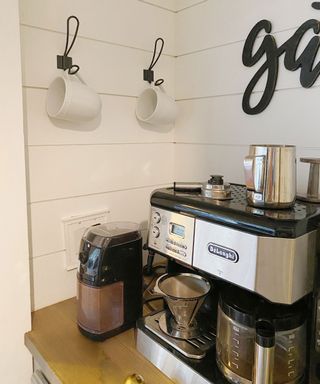 Coffee nook with coffee maker and hanging cups on wooden countertop material