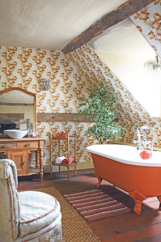 Traditional bathroom with orange roll top bath