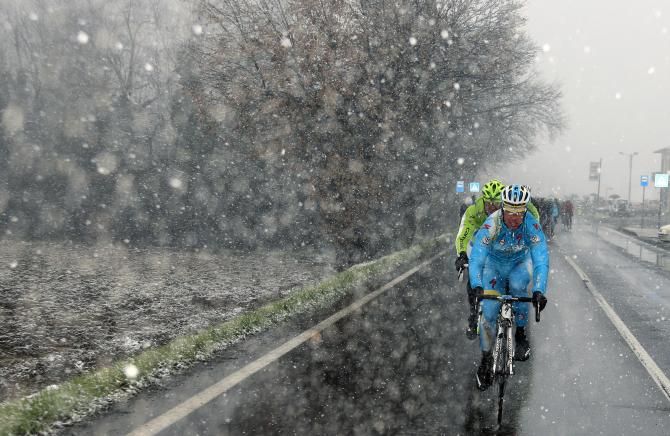 The peloton battle the conditions at Milano-Sanremo