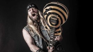 Zakk Wylde branding a guitar (studio portrait)