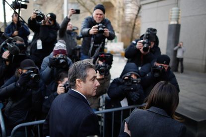 Michael Cohen surrounded by reporters and photographers