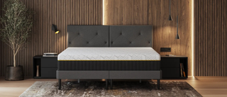 The white Emma Hybrid Airgrid mattress in a bedroom