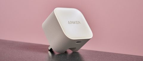 Anker Nano USB-C Wall Charger (30W) on black surface, against pink background